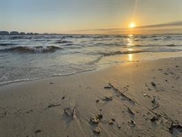 yacht-club-beach-sunset-with-sand-and-waves